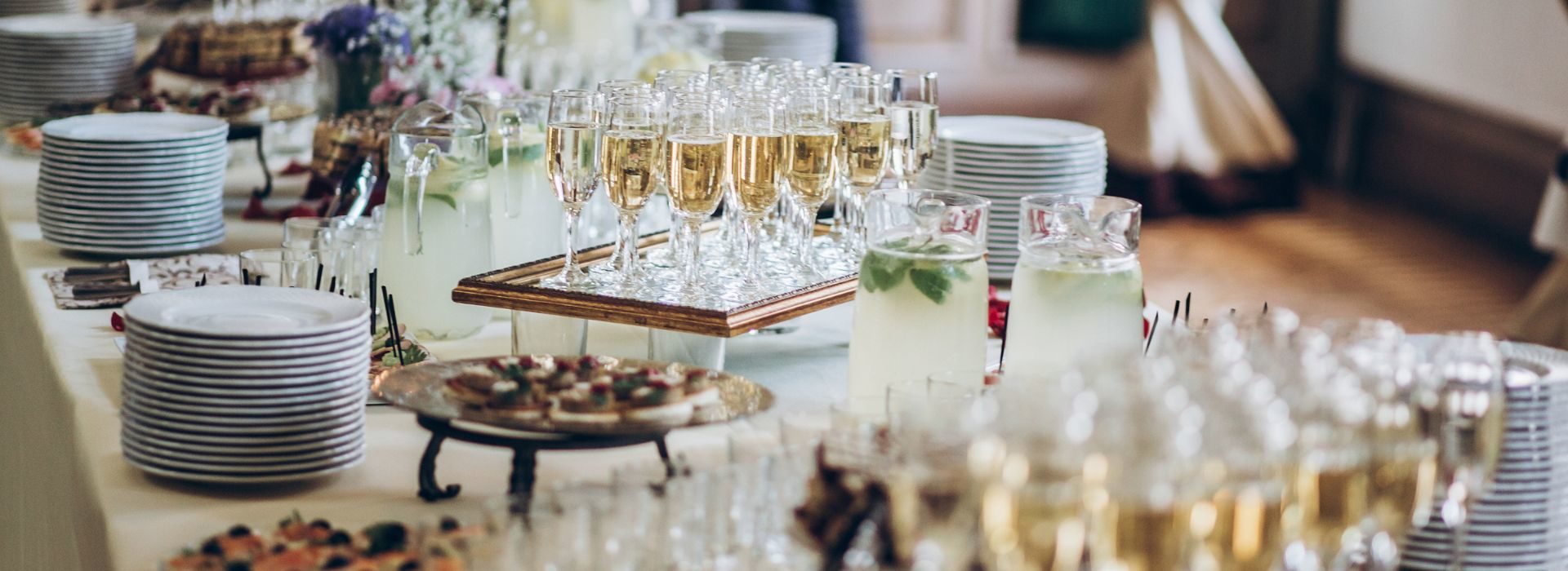 A table set up with plates, food, and champagne