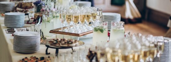 A table set up with plates, food, and champagne