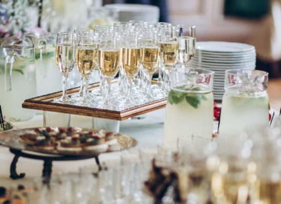 A table set up with plates, food, and champagne