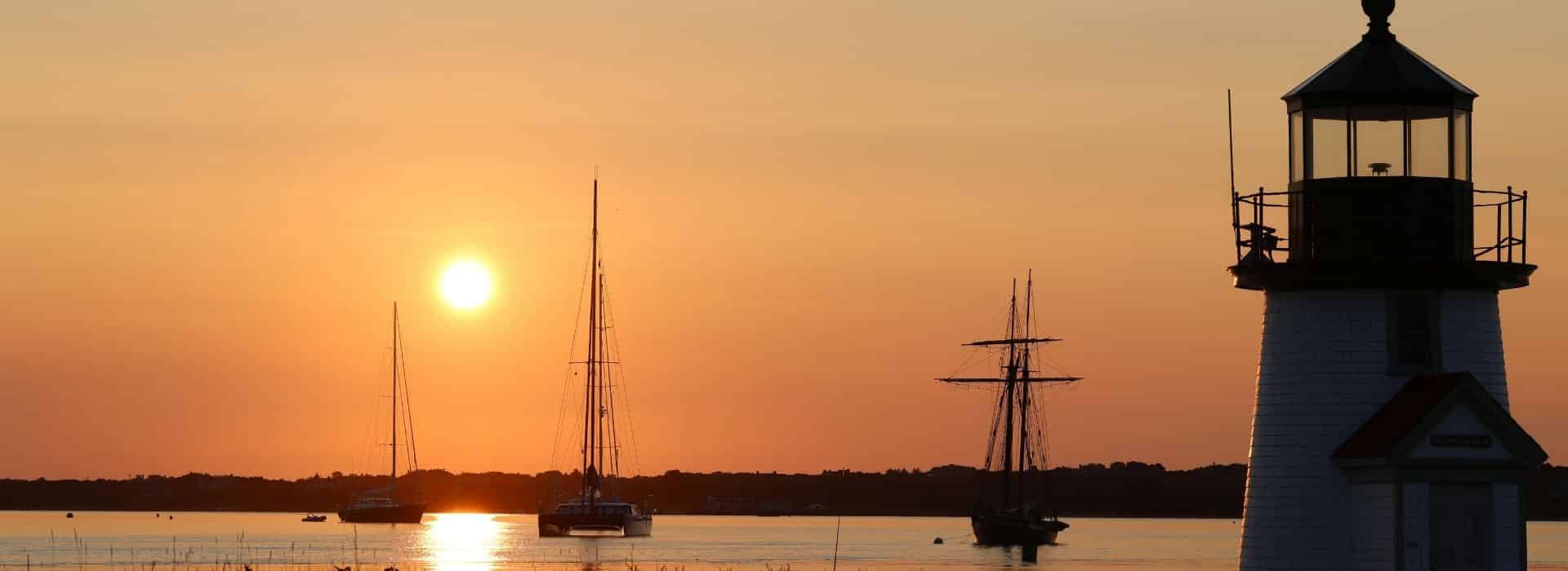 Sunset over Brant Point Lighthouse and Nantucket Harbor during the fall season