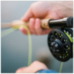 Up close shot of a fishing reel with green line - image by carl heyerdahl unsplash.com