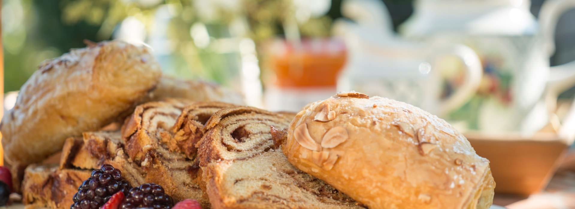 Close up view of a variety of pastries and bread