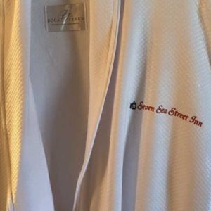 White robe with embroidered Seven Sea Street text in red